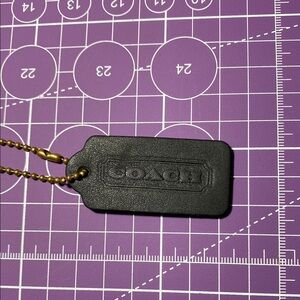Coach Black Leather Tag with Gold Chain.